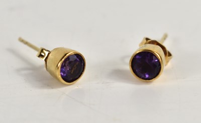 Lot 103 - A pair of gold and amethyst stud earrings,...