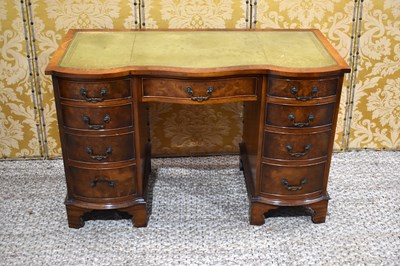 Lot 399 - A 20th century desk, with shaped front, two...