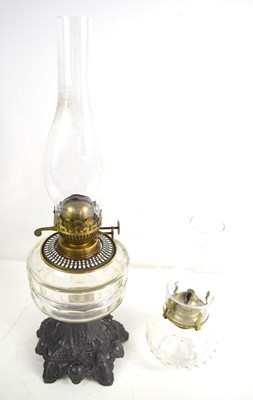 Lot 351 - An antique oil lamp with cast iron base...