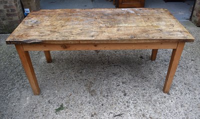 Lot 410 - An antique elm top kitchen table raised on...