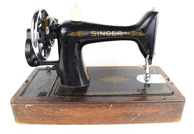 Lot 79 - A vintage Singer sewing machine with oak case.