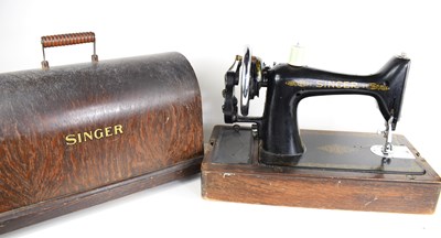 Lot 79 - A vintage Singer sewing machine with oak case.