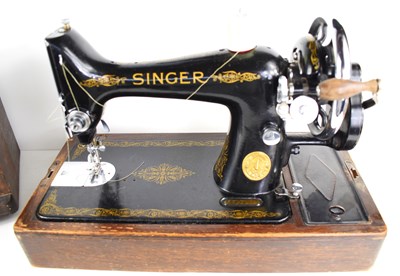 Lot 79 - A vintage Singer sewing machine with oak case.