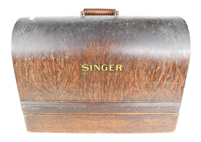 Lot 79 - A vintage Singer sewing machine with oak case.