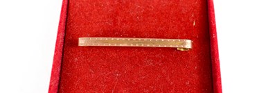 Lot 7 - A 9ct gold tie pin, engraved with decoration,...