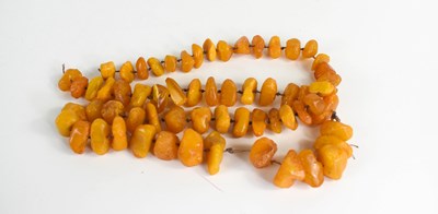 Lot 113 - A butterscotch amber necklace, composed of...