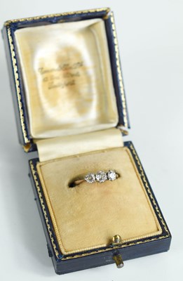 Lot 119 - A gold and diamond three stone ring, the...