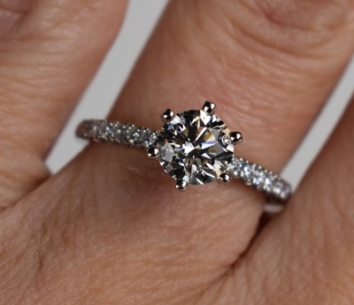 Lot 18 - A platinum and diamond solitaire ring, the...