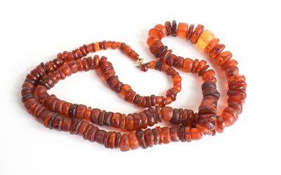 Lot 147 - A vintage amber beaded necklace, rough cut...