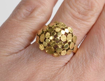 Lot 25 - An 18ct gold modernist ring, the domed setting...