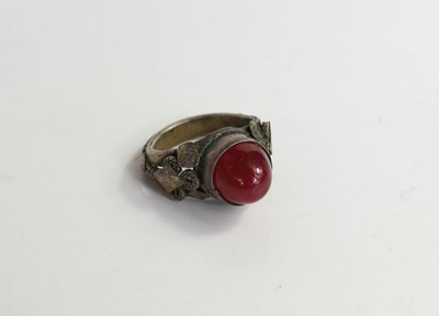 Lot 172 - A white metal ring, set with a carnelian...