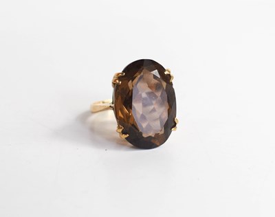 Lot 203 - A 9ct gold and smoky quartz dress ring, the...