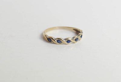 Lot 204 - An 18ct gold and sapphire ring, twist form set...