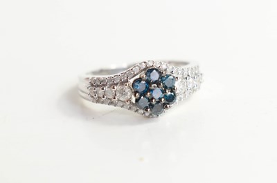 Lot 219 - A 9ct white gold, blue & white diamond cluster...