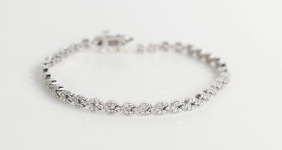 Lot 221 - An 18ct white gold and diamond tennis bracelet,...