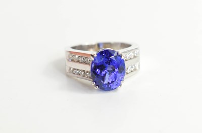 Lot 223 - A 14k white gold, tanzanite and diamond ring,...