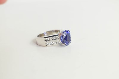 Lot 223 - A 14k white gold, tanzanite and diamond ring,...