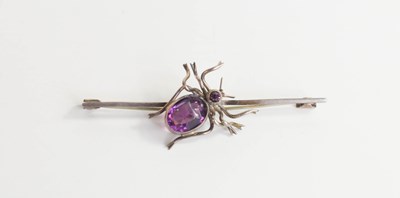 Lot 32 - A silver and amethyst set bar brooch, centred...