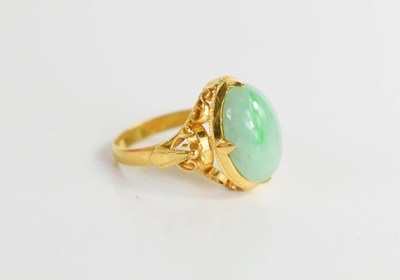 Lot 245 - A Chinese gold and jade ring, the cabochon...