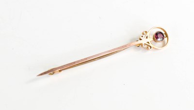 Lot 332 - A 9ct gold and ruby tie pin, the brilliant cut...