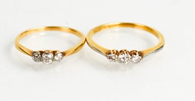 Lot 111 - Two similar 18ct gold and diamond trilogy...