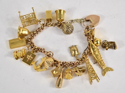 Lot 272 - A 9ct gold charm bracelet with various 9ct,...