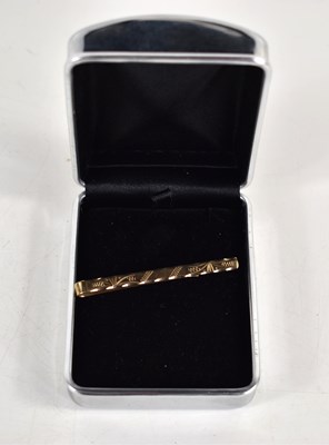 Lot 277 - A 9ct gold tie clip, with engraved decoration...