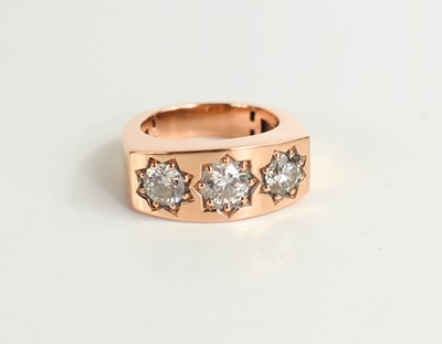 Lot 285 - An 18ct rose gold three stone gypsy ring, the...