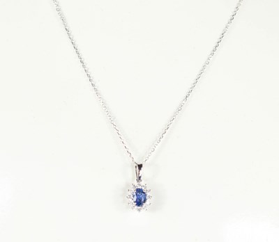 Lot 200 - An 18ct white gold oval sapphire and diamond...