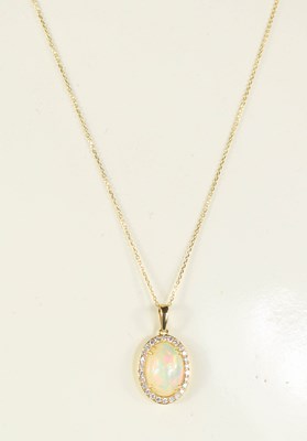 Lot 201 - A 9ct yellow gold oval cabochon opal and...