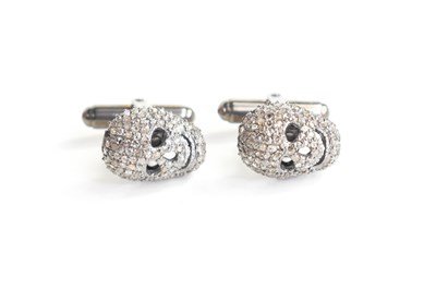 Lot 202 - A pair of silver diamond set skull form...