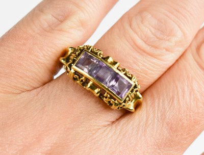 Lot 37 - A 14ct gold and amethyst three stone ring in...