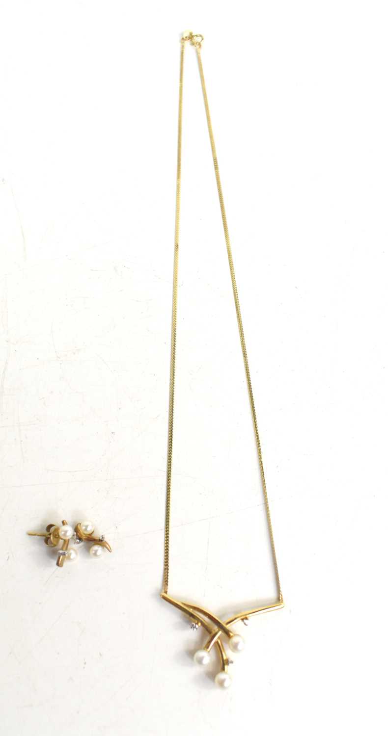 Lot 22 - A 9ct gold, pearl and diamond set pendant...