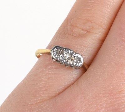 Lot 89 - A 9ct gold and diamond ring, three chip...