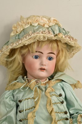 Lot 98 - A German bisque porcelain head doll, wearing...