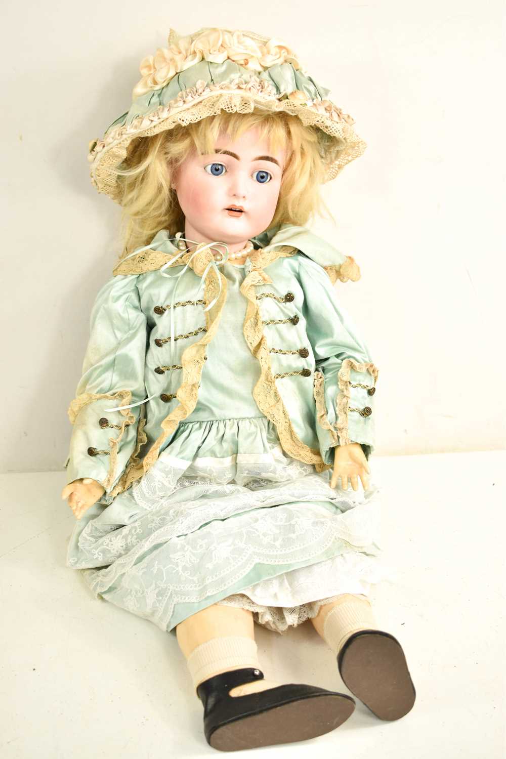 Lot 98 - A German bisque porcelain head doll, wearing...