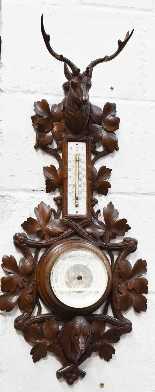 Lot 307 - A 19th century Blackforest barometer, carved...