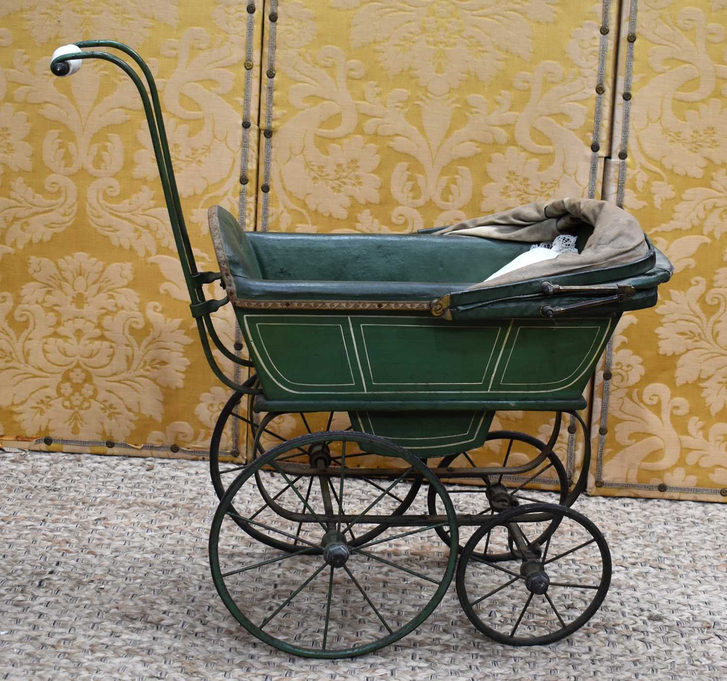 Lot 96 - A Victorian doll's pram c. 1890 with green...