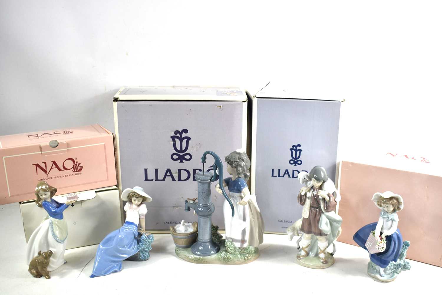 Lot 318 - A group of Lladro and Nao porcelain figurines...