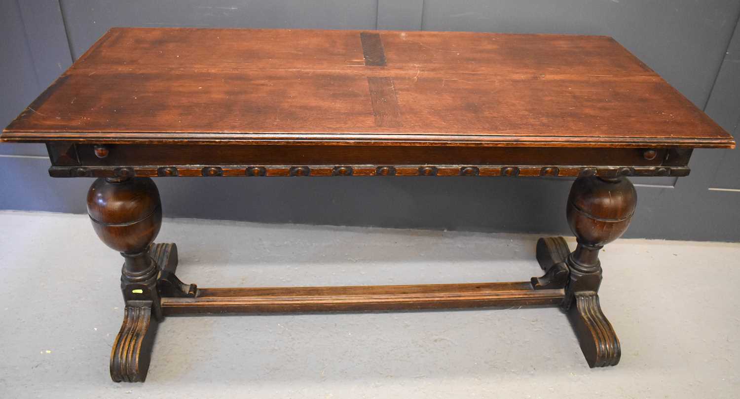 Lot 530 - An oak drawer leaf dining table with large...