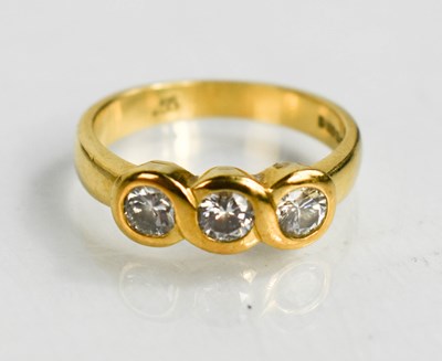 Lot 70 - An 18ct gold and diamond trilogy ring, the...