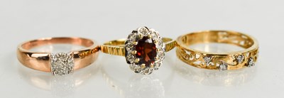 Lot 159 - A 9ct gold, diamond and garnet flowerhead ring,...