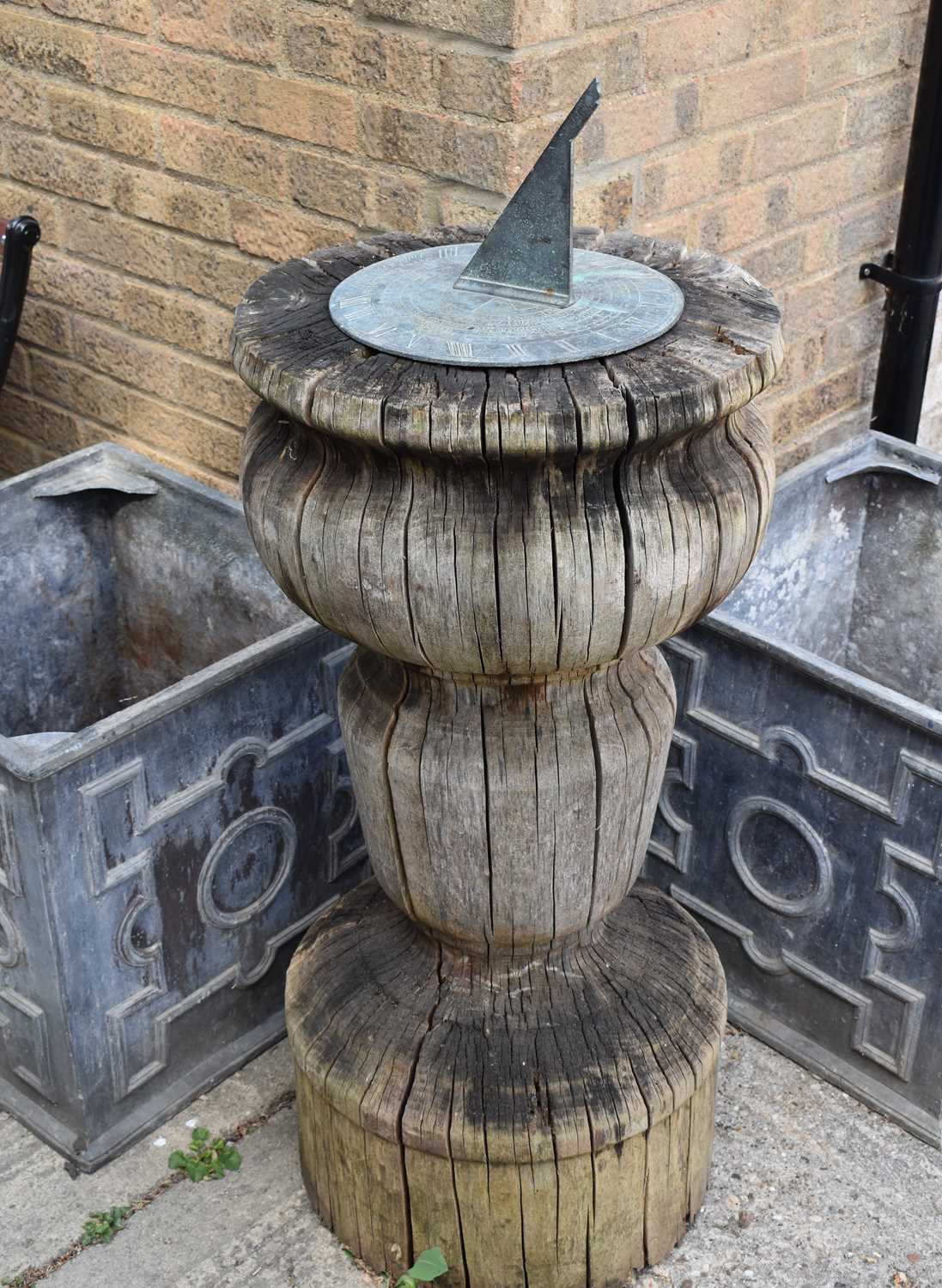 Lot 558 - A bronze sundial on a large carved oak stand.