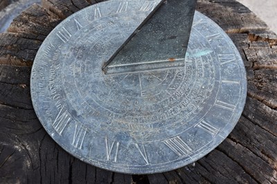 Lot 558 - A bronze sundial on a large carved oak stand.