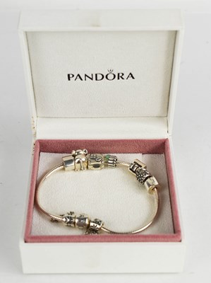 Lot 160 - A Pandora bracelet, with five charms, with the...