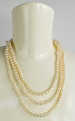 Lot 163 - A 9ct gold and pearl triple strung necklace,...