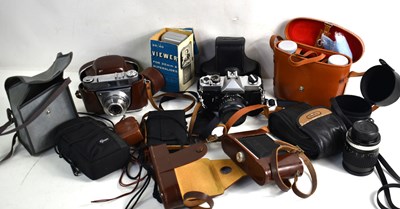 Lot 438 - A group of vintage cameras and lenses to...
