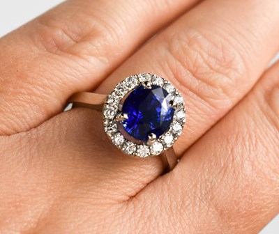 Lot 30 - A platinum, sapphire and diamond cluster ring,...