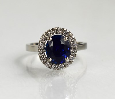 Lot 30 - A platinum, sapphire and diamond cluster ring,...