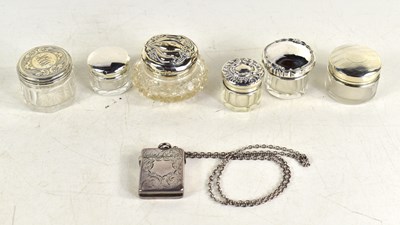 Lot 245 - A group of silver lidded glass jars together...